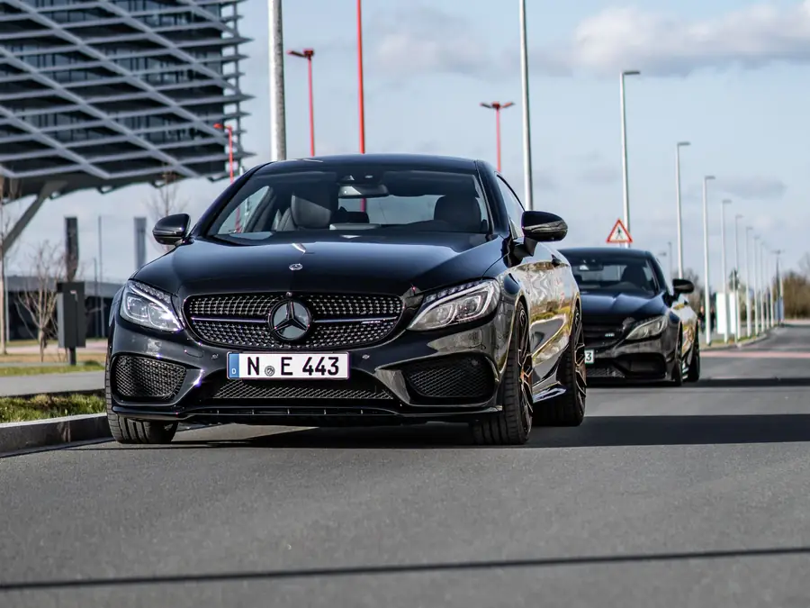 Black Mercedes-Benz C200 AMG Line on an open road