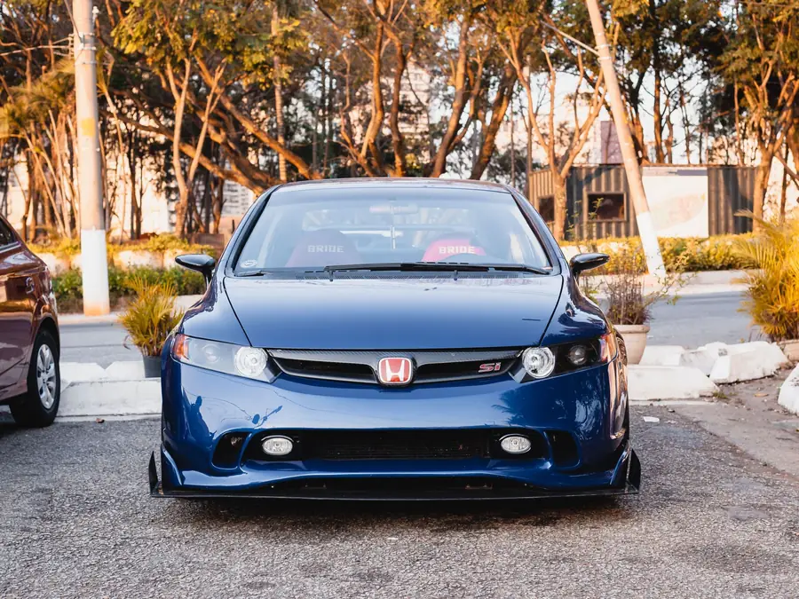 Blue Honda Civic 2.0 S parked under autumn trees